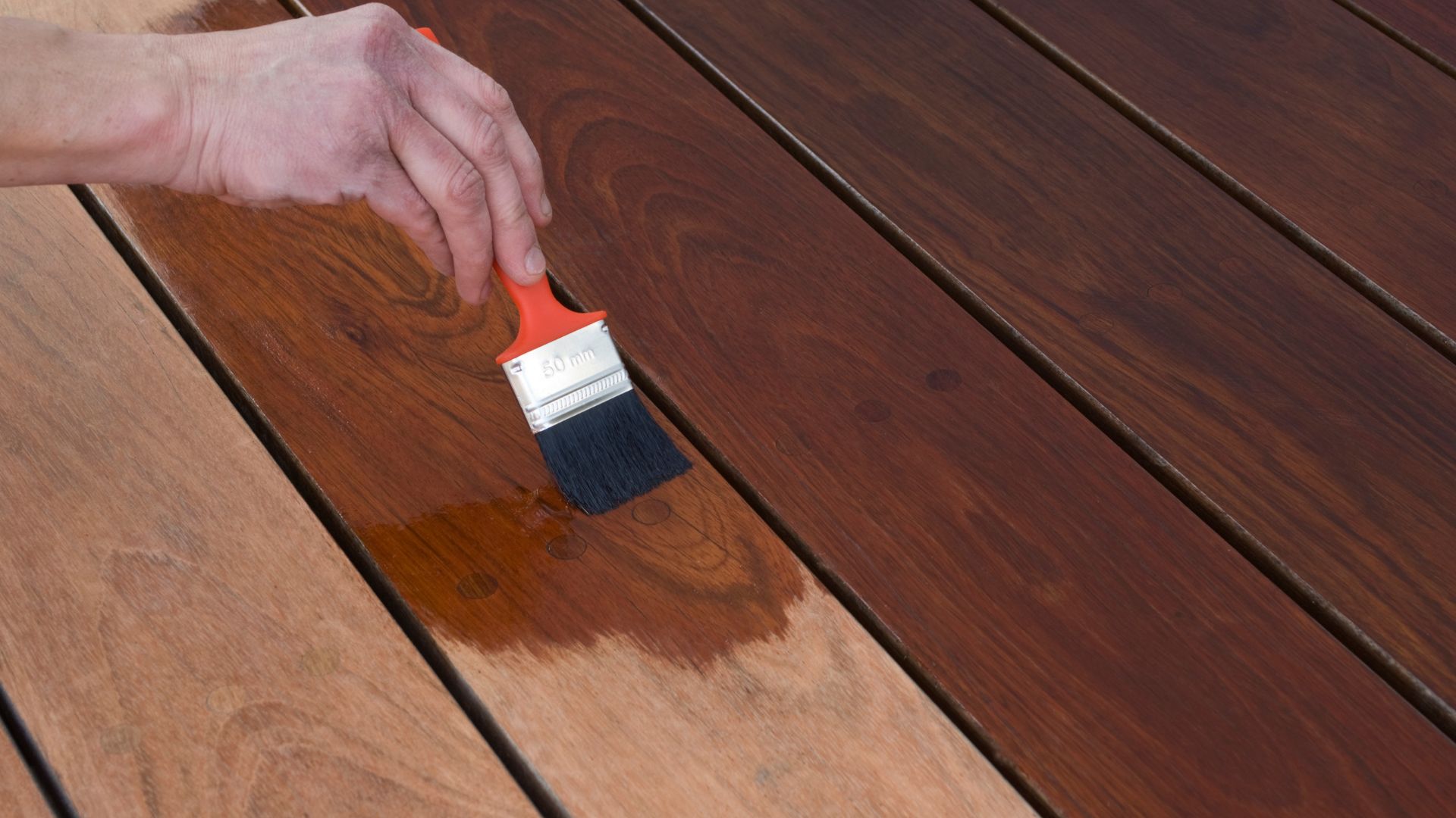 professional staining wood with paint brush