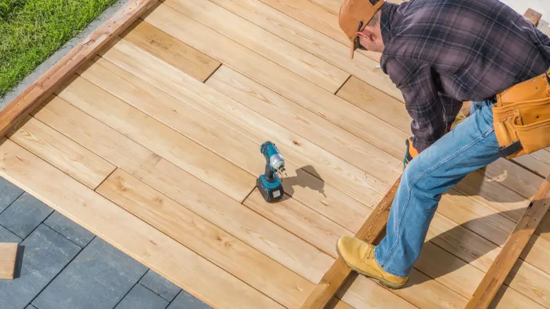 Skilled carpentry services building a sturdy wooden deck, ensuring quality craftsmanship for a durable and stylish outdoor space.
