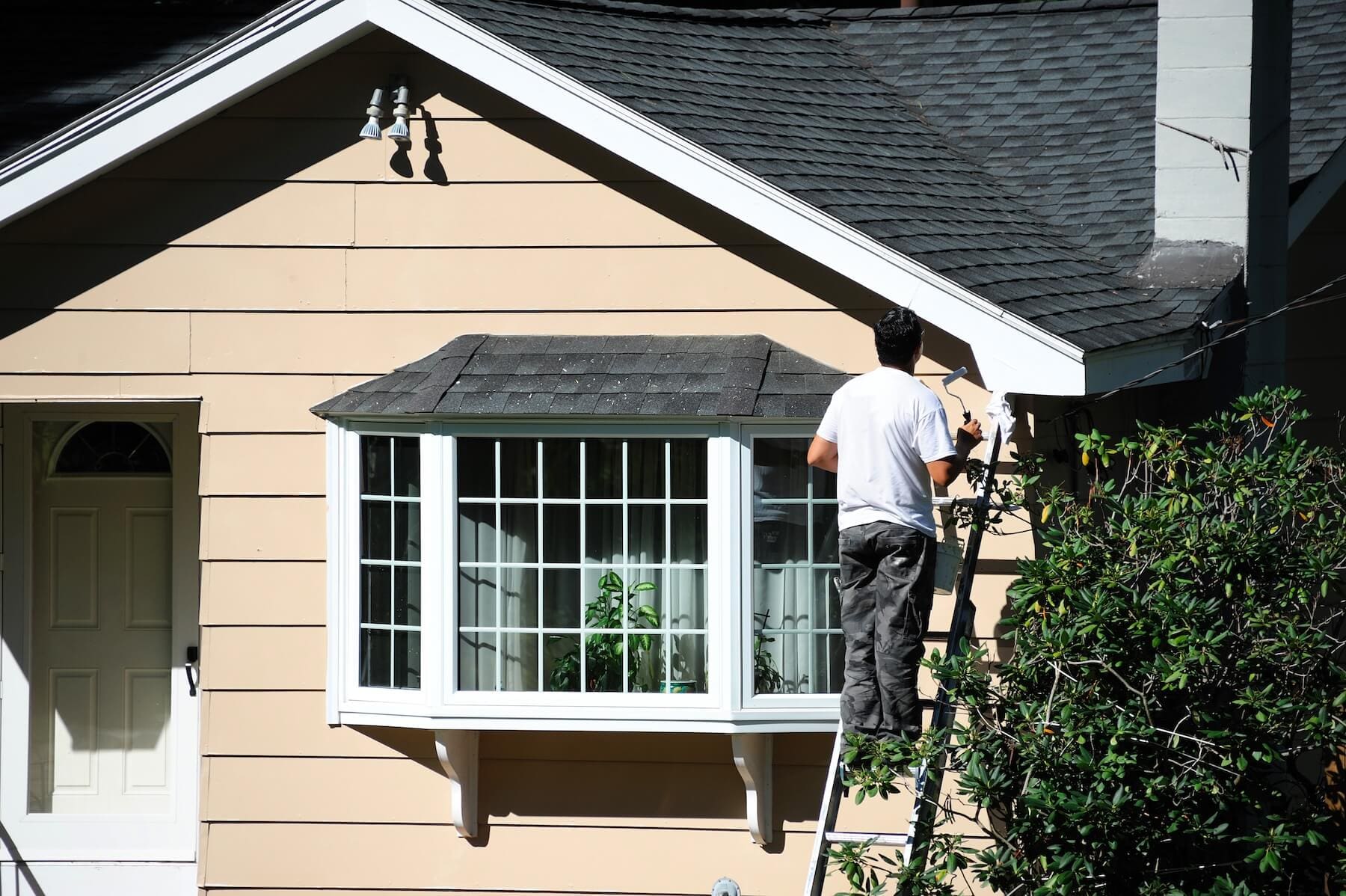 Painter working on the exterior trim of a Hood River home