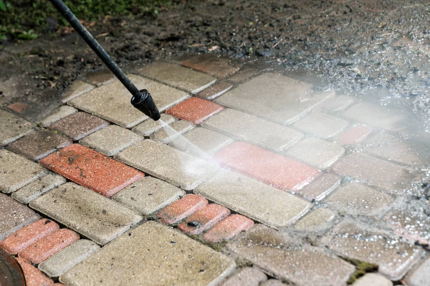 Pressure washing a brick paver patio at a Hood River home