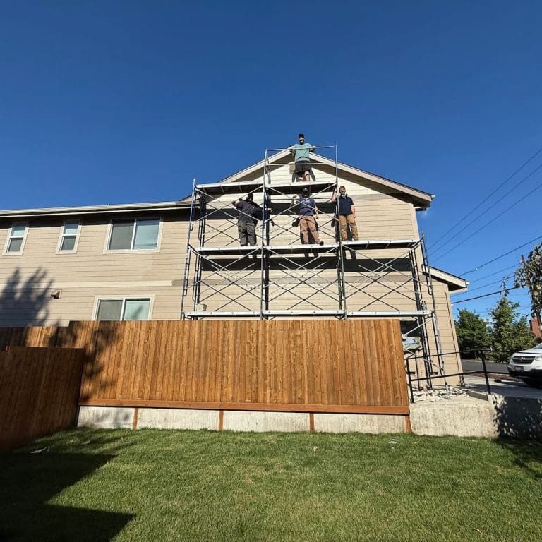 Full Bloom painting crew preparing an exterior for coating