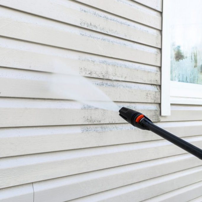 Pressure washing house siding at a White Salmon, WA home
